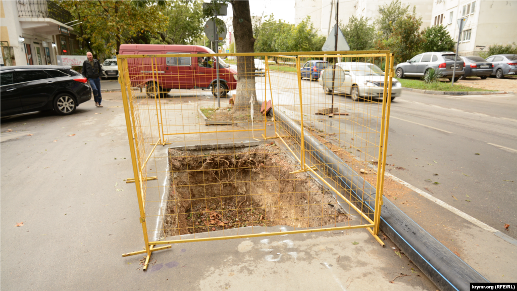 Легкое ограждение возле глубокой ямы на тротуаре на улице Николая Музыки